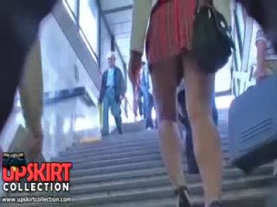  teen in high heeled shoes and checked skirt is going upstairs showing the Sexy 